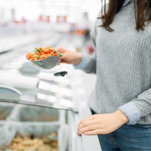 冷凍野菜のパックを手に取る女性