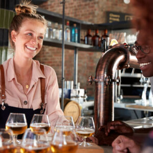 waitress serves beer at bar